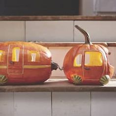 two carved pumpkins sitting on top of a counter