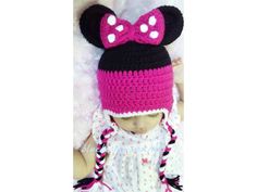 a baby girl wearing a minnie mouse hat