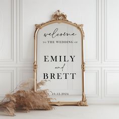 a sign that says welcome to the wedding of emily and breit on it next to dried flowers