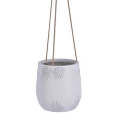 a white planter hanging from a rope