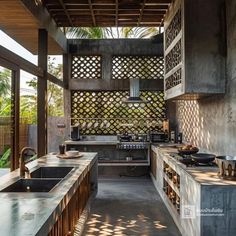 an outdoor kitchen with concrete counter tops and wooden cabinets