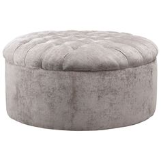 a round ottoman that is made out of grey velvet with an upholstered top