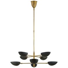 a brass chandelier with five black shades