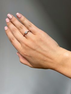 a woman's hand with a diamond ring on her left wrist, holding out her right hand