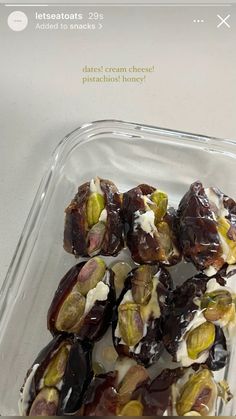 there is a plastic container filled with chocolate covered dates and almonds on the side