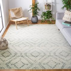 a living room with a couch, chair and rug