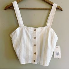 -New With Tag -Adjustable Straps -Square Neckline -White And Cream Striped Print -Wooden Button Detail 85% Cotton 15% Linen Pit To Pit 16" Length 10" White Button-up Crop Top For Summer, White Buttoned Top For Beach, Summer Button-up Crop Top With Button Closure, Summer Buttoned Crop Top, White Cropped Crop Top With Button Closure, White Buttoned Top For Vacation, Summer White Tops With Adjustable Straps, Summer White Top With Adjustable Straps, White Cropped Top With Adjustable Straps