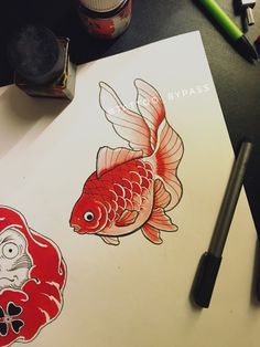 a drawing of a goldfish and an angry fish on a piece of white paper