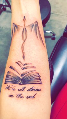 a person with a book tattoo on their arm