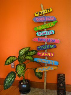 there is a plant in front of a sign that says tahiti, borabora, morera, rainforest, rangua, tikehou, tikehu, taha and taha