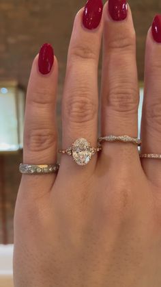 a woman's hand with two rings on it and a ring in the middle