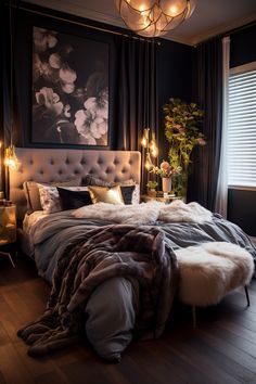 a bedroom with a large bed covered in blankets and lights next to a painting on the wall