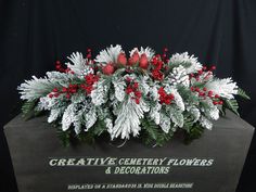 a christmas centerpiece with red berries and greenery on it's base is shown