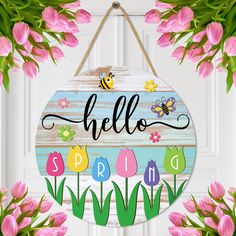 a wooden sign that says hello spring with flowers and a bee hanging from the front door