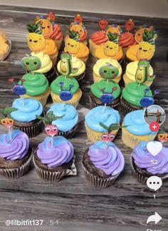 there are many cupcakes on the table with different colors and designs in them