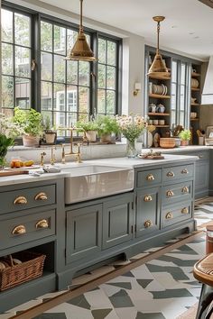 a large kitchen with lots of windows and green cupboards in the middle of it