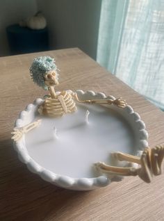 a skeleton sitting on top of a white plate