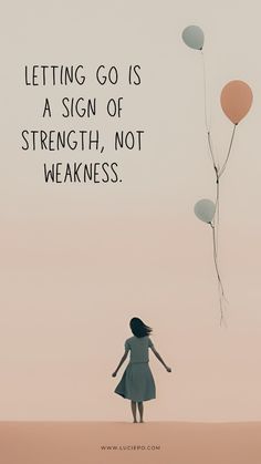 a woman standing in the sand with balloons flying above her, saying letting go is a sign of strength, not weakness