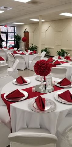 the tables are set with red and white linens