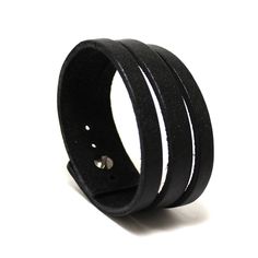 Minimalist narrow and chick men leather cuff of genuine leather (approx 3 mm thickness) in deep black color with soft gloss effect. One screw leather stud used as clasp. Not very wide but looks as many bracelets on a wrist. Our other bracelets here https://etsy.com/shop/PrideAndBright ★ SPECIFICATIONS ★ * Handmade product * Natural Tanned Leather * Color: black color * Size: Best suited for wrist size from 6.7in/16cm till 7.5in/19cm * Screw button stud Everyday Black Leather Cuff Bracelet, Modern Black Leather Cuff Bracelet, Modern Leather Wristband With Black Band, Modern Black Leather Wristband, Modern Black Leather Strap Wristband, Modern Adjustable Cuff Leather Bracelet, Minimalist Leather Bracelets With Leather Strap, Modern Leather Cuff Bracelet, Modern Leather Bracelet For Business