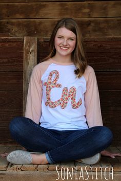 Show your Tennessee pride when you wear this baseball tee with a Tennessee applique in a delicate floral fabric. This is a super soft, super comfy Bella + Canvas Unisex baseball tee offered in a white body with peach sleeves. Sizes available are Small through 2X. The sizes are described as Unisex, retail fit. If you need more information, send me a message and I can give you more information. Each shirt is hand decorated in a smoke free home. ---Ordering information--- Select your size from the Varsity T-shirt With Embroidered Graphics For Fall, Spring Varsity T-shirt With Graphic Print, Spring Graphic Tee With Raglan Sleeves, Spring Cotton Varsity T-shirt, Varsity Style Letter Print Tops For Spring, Fall Varsity T-shirt With Embroidered Graphics, Cute Cotton Tops With Floral Applique, Cotton Tops With Floral Applique In Cute Style, Cute Cotton Top With Floral Applique