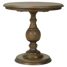 a round wooden table with an iron base and wood grained finish on the top