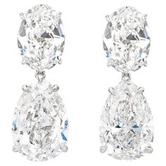 These luxurious GIA certified dangle earrings showcase a harmonious blend of pear and oval cut diamonds set in 18K white gold. The pear-shaped diamonds, weighing 3.01 and 3.05 carats respectively, take center stage, while the smaller oval-cut diamonds are elegantly positioned above them, adding graceful balance. With an F color grade, these diamonds exhibit a near-colorless brilliance, while their internally flawless clarity ensures a pristine appearance. The cut and polish of all diamonds are graded excellent, maximizing their sparkle. One diamond boasts excellent symmetry, while the other has a very good rating. With no fluorescence in one diamond and faint in the other, these earrings are a true testament to timeless elegance and craftsmanship. Luxury Pear-shaped Fine Jewelry Earrings, Luxury Gia Certified White Earrings, Earrings Expensive, Pear Diamond Earrings, Lux Jewelry, Luxe Jewelry, Diamond Dangle Earrings, Precious Jewels, Expensive Jewelry