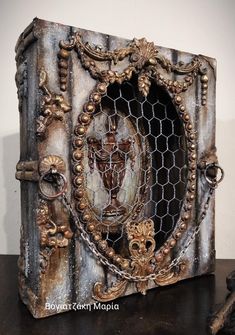 an intricately decorated wooden box sitting on top of a table