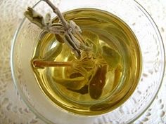 an overhead view of a glass cup filled with tea and some dried leaves in it