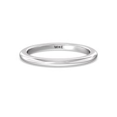 a white gold wedding band with the word wlc on it's center side