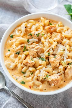 a white bowl filled with macaroni and cheese on top of a blue cloth