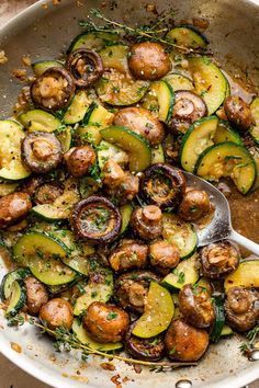 a skillet filled with cooked zucchini and mushrooms