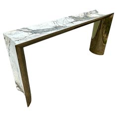 a white marble and metal console table