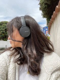 a woman with headphones on her ears