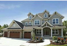 a large house with two garages on the front and one story in the back