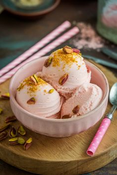 Three scoops of pink ice cream topped with crushed pistachios in a bowl, with pink straws and a spoon on the side. Crunchy Toppings, Maple Ice Cream, Unique Ice Cream Flavors, Ice Cream Aesthetic, Unique Ice Cream, Dessert Cravings, Homemade Iced Coffee, Bar At Home, Lime Sorbet