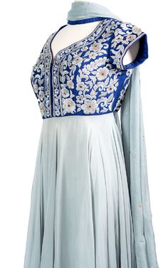 An elegant cool blue chiffon Anarkali drapes beautifully across the body and stands out with a raw silk royal blue top with tonal thread and zari embroidery.Length: 63Fabric: Top - Raw Silk, Gown / Dupatta - ChiffonEmbroidery: Thread, Stone Blue Art Silk Dress With Intricate Embroidery, Blue Churidar With Sheer Dupatta, Fitted Blue Churidar With Sheer Dupatta, Blue Embroidered Gown With Traditional Drape, Elegant Blue Churidar With Intricate Embroidery, Blue Choli With Chikankari Embroidery For Wedding, Blue Silk Floor-length Lehenga, Transitional Blue Silk Choli, Blue Lehenga With Chikankari Embroidery