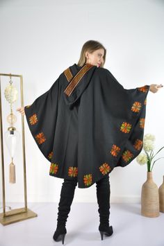 This vintage cape jacket is definitely a vintage fashion statement. It is 100% hand embroidered with geometrical patterns. It can be used over a jeans and shirt or sweater. Great to keep you warm. Please note that the capes we have at the moment (Option #1 and Option #2) are without a hoodie but they are just as beautiful and practical. Material : Wool Length : 49 inches Size : One size fits all. We ship your order with DHL express within one to two business days. Orders to Europe will typically Traditional One Size Hooded Poncho, Hooded Fall Festival Poncho, Traditional Black Cape For Fall, Traditional Hooded Winter Poncho, Bohemian Hooded Cape For Festivals, Embroidered Cape Outerwear For Fall, Bohemian Style Winter Cape Outerwear, Fall Festival Cape Poncho, Winter Long Sleeve Festival Cape