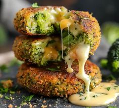 broccoli and cheese patties stacked on top of each other with sauce drizzled over them