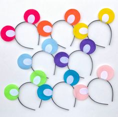 a bunch of different colored paper circles on a white surface