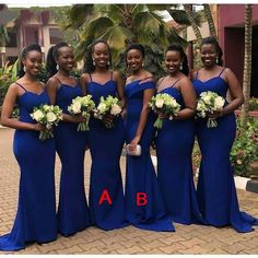 a group of women standing next to each other wearing blue dresses and holding bouquets