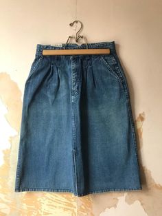 80’s denim skirt has a pleated front with deep front pockets, and small back pockets and belt loops for a slim belt. By Tres Classique. Faint pinstripe in denim. Front kick pleat. In good shape. Measurements in photo. Sized “14” but it is not a 14- I’ll size at a woman’s lg / size 10. Vintage Relaxed Fit Skirt For Spring, Vintage Dark Wash Bottoms For Spring, Vintage Cotton Denim Skirt For Spring, Retro Denim Skirt For Fall, Vintage Relaxed Skirt For Spring, Vintage Medium Wash Skirt For Summer, Vintage Dark Wash Denim Skirt For Spring, Cotton Pleated Skirt In Medium Wash, Vintage Denim Skirt With Pockets For Spring