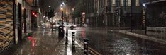 a city street at night in the rain