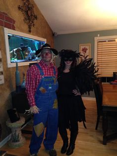 a man and woman dressed up in costumes standing next to each other on a hard wood floor