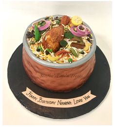 a birthday cake made to look like a bowl of noodles and vegetables with the words happy birthday nanna love you