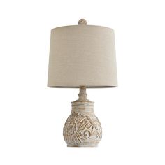 a white lamp with a beige shade on it's base and a light bulb in the shape of a flower