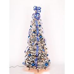 a small christmas tree with blue and white ribbons on it's top, in front of a white background