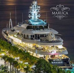 a large white boat in the water at night