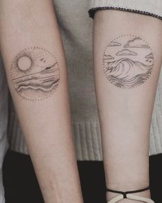 two people with matching tattoos on their arms, one is holding the other's arm