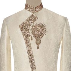 and Khussa This elegant off-white sherwani is the perfect attire for your wedding day. The angrakha style flatters a variety of body types, and the premium quality, self-textured fabric provides a luxurious look and feel. The sherwani is adorned with intricate golden and maroon traditional handwork, making it a truly special piece. Color: Off-white Style: Angrakha Material: Premium quality, self-textured fabric Embroidery: Golden and maroon traditional handwork Includes: Sherwani, Maroon Aitchis White Nehru Jacket For Wedding And Festivals, White Nehru Jacket For Wedding Festivities, White Nehru Jacket For Wedding And Transitional Season, Cream Nehru Jacket For Wedding And Festivals, Transitional Season White Nehru Jacket For Weddings, White Traditional Wear With Dabka For Wedding, White Dabka Traditional Wear For Wedding, Wedding Naqshi Cream Nehru Jacket, White Traditional Wedding Wear With Dabka